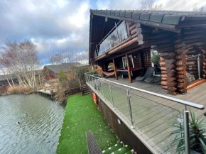 Woodpecker Log Cabin with hot tub, pizza oven bbq entertainment area, lakeside with private fishing peg situated at Tattershall Lakes